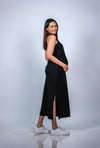 Side view of black maternity bodycon maxi dress, highlighting the form-fitting silhouette that flatters a growing bump.