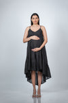 Front view of black maternity layered high-low dress with spaghetti straps, featuring a flowy silhouette perfect for pregnancy.