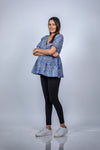Angled front view of Blue Blossom Fit & Flare Maternity Top, showcasing a flattering fit and flare silhouette with a floral pattern for expecting mothers.