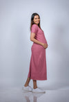 Angled view of Blush Pink Maternity T-Shirt Dress, offering a minimalist and elegant design perfect for everyday maternity comfort.