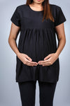 Close-up of the Classic Black Maternity T-Shirt, highlighting the babydoll-style fit with ample room for the growing bump.