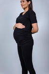 Side view of Classic Black Ruched Maternity T-Shirt, highlighting the flattering ruching along the sides for a growing bump.