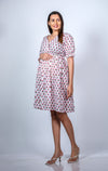 Angled view of Classic White Maternity Dress, showcasing a chic and relaxed fit for casual outings.