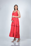 Angled view of Coral Red Maternity Layered Sleeveless Buttoned Maxi Dress, highlighting the vibrant coral color and button detail.