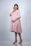 Angled view of the Pink Floral Maternity Fit & Flare Bell-Sleeve Dress, highlighting the soft, floral pattern and feminine design.