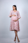 Front view of the Pink Floral Maternity Fit & Flare Bell-Sleeve Dress, showcasing the flattering fit for expecting moms.