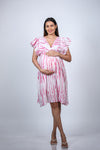 Angled view of Pink Tie-Dye Maternity Fit & Flare Dress, showcasing the flattering fit and vibrant tie-dye design.