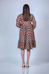 Back view of printed maternity fit & flare dress with ruffled hem and balloon sleeves, offering both comfort and style for moms-to-be.
