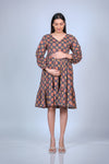 Pose variation featuring the printed maternity fit & flare dress with balloon sleeves and ruffled hem, providing a stylish and flattering fit for moms-to-be.