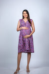 Side view of the Purple Floral Maternity Fit & Flare Dress, offering a glimpse of the graceful silhouette and growing bump.