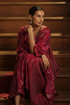 Seated front view of Regal Maroon Maternity Kurti Set with Dupatta, featuring golden accents and a flowing silhouette, perfect for festive occasions.