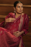 Seated pose of Regal Maroon Maternity Kurti Set with Dupatta, featuring a sophisticated design with golden accents and a flowing fit for expecting mothers.