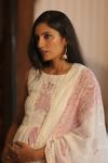 Low-light view of Serene Pink & White Maternity Kurti Set, featuring soft pink embroidery and a comfortable, flowing fit for expecting mothers.