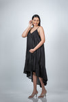 Angled view of black maternity layered high-low dress, highlighting its modern high-low hem and comfortable, stylish fit for pregnancy.