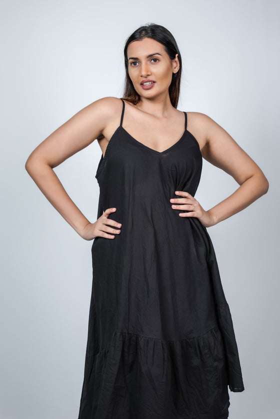 Front pose of black maternity layered high-low dress with spaghetti straps, featuring a relaxed fit and flowy design for pregnant moms-to-be.