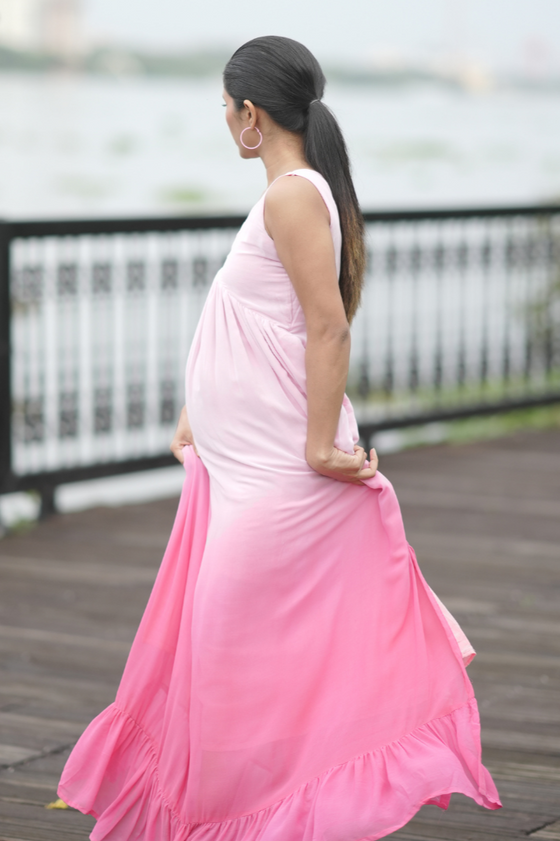 Side view of Blush Ombre Maternity Evening Gown, showcasing its flowing silhouette and sleeveless design, perfect for moms-to-be.