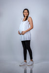 Angled view of Classic White Sleeveless Maternity Tunic, highlighting the flattering fit and ample space for the growing bump.