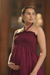 Side view of Maroon Halter-Neck Maternity Evening Gown, showcasing the flattering halter-neck design and smocked bodice for comfort and elegance during pregnancy.