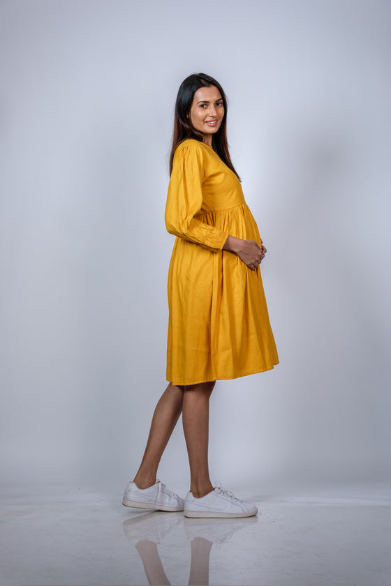 Side view of Mustard Yellow Fit & Flare Maternity Dress, showcasing the flattering silhouette and ample space for a growing bump.