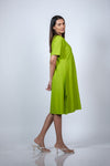 Side-angle view of the Neon Green Maternity A-Line T-Shirt Dress, showing the dress's ease of movement.