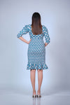 Back view of a printed maternity bodycon dress with ruffled hem, designed for comfort and style throughout pregnancy.