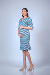 Front view of a printed maternity bodycon dress with 3/4 sleeves and ruffled hem. Comfortable and stylish design for moms-to-be.