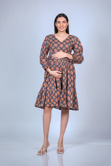 Front view of printed maternity fit & flare dress with balloon sleeves and ruffled hem, designed for a stylish and comfortable fit for moms-to-be.