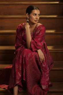  Seated front view of Regal Maroon Maternity Kurti Set with Dupatta, featuring golden accents and a flowing silhouette, perfect for festive occasions.