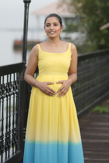  Front view of Sun-Kissed Ombre Maternity Evening Gown, featuring a vibrant yellow-to-blue ombre, sleeveless design, and scoop neckline for moms-to-be.