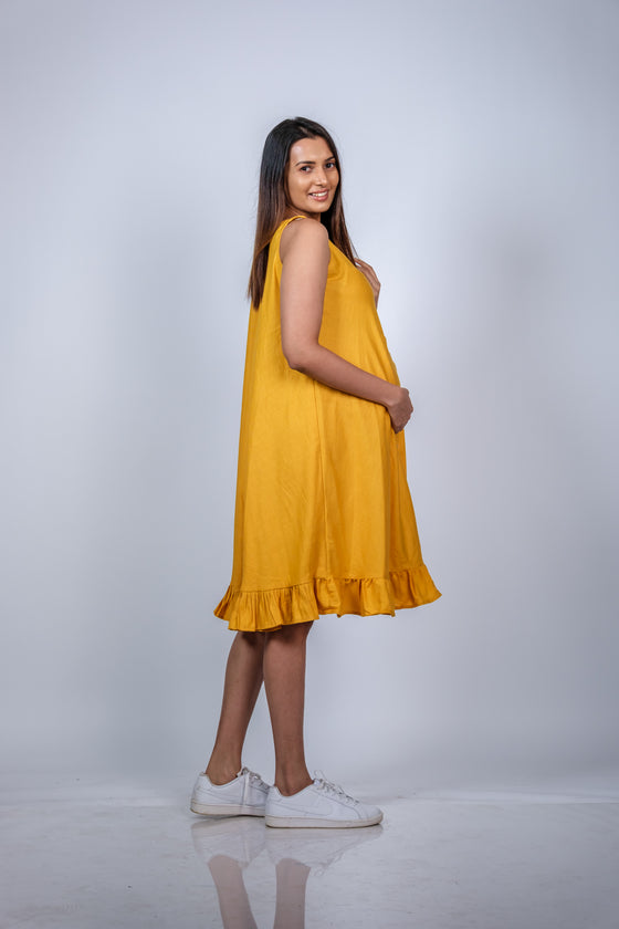 Angled view of Sunshine Yellow Fit & Flare Maternity Dress, offering a stylish yet comfortable fit perfect for casual or dressy occasions.