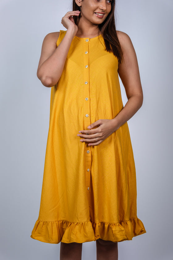Close-up of Sunshine Yellow Fit & Flare Maternity Dress, featuring a flattering fit and vibrant yellow color for an effortlessly stylish maternity look.