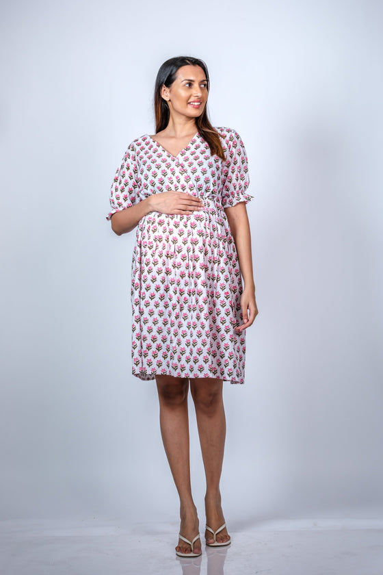 Front view of White Floral Fit n' Flare Maternity Dress, showcasing a comfortable and stylish fit for moms-to-be.